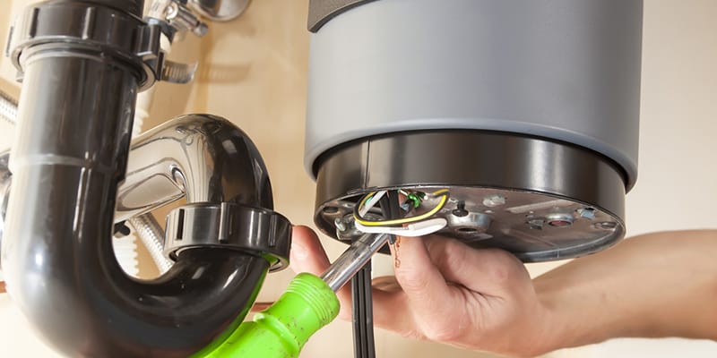 Technician repairing the heating element of a water heater in Desert Hot Springs