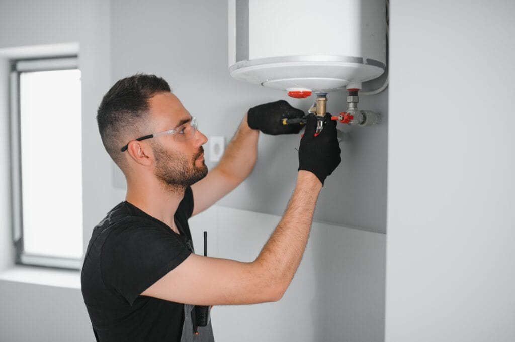 Technician performing water heater maintenance in Desert Hot Springs