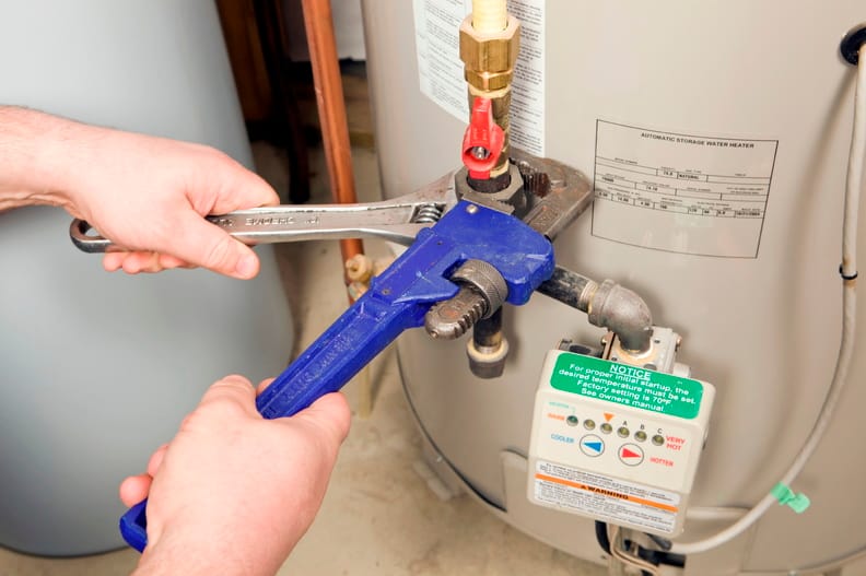 Plumber repairing a water heater valve in Desert Hot Springs